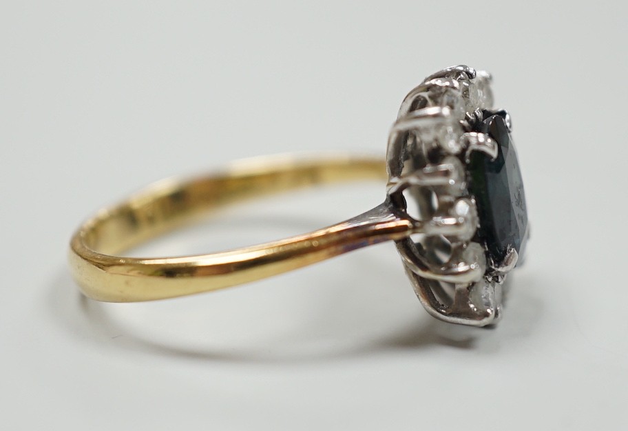 An 18k yellow metal, sapphire and diamond set rectangular cluster ring, size M, gross 4 grams.